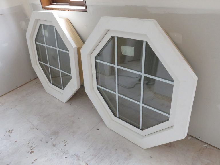 Two octagonal white-framed windows indoors.