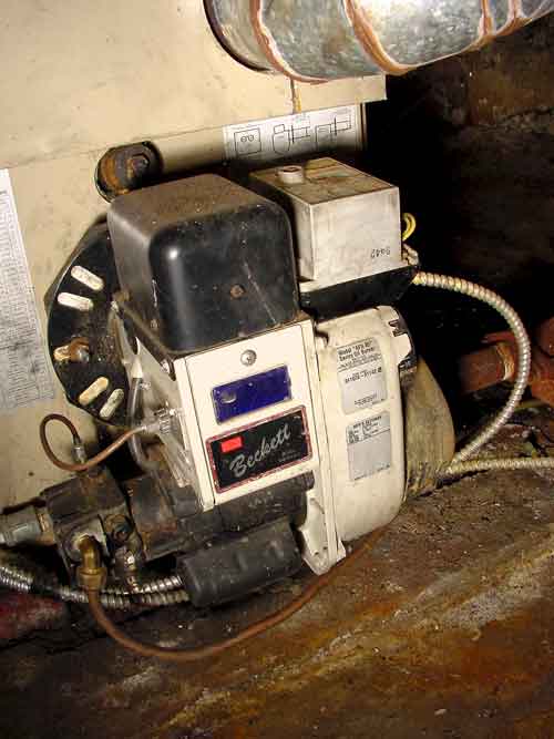 Residential furnace oil burner close-up view.