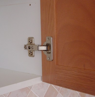 Cabinet door hinge installation close-up