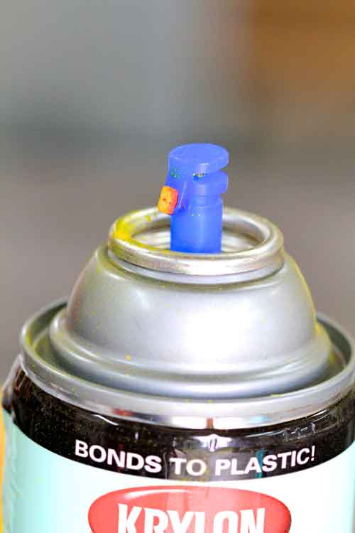 Close-up of spray paint can nozzle.