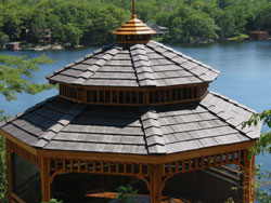 Wooden gazebo overlooking a tranquil lake view.