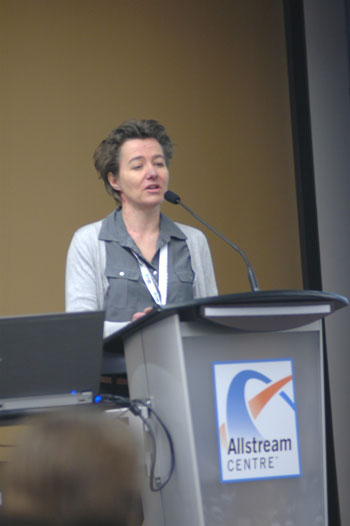 Person speaking at Allstream Centre podium.