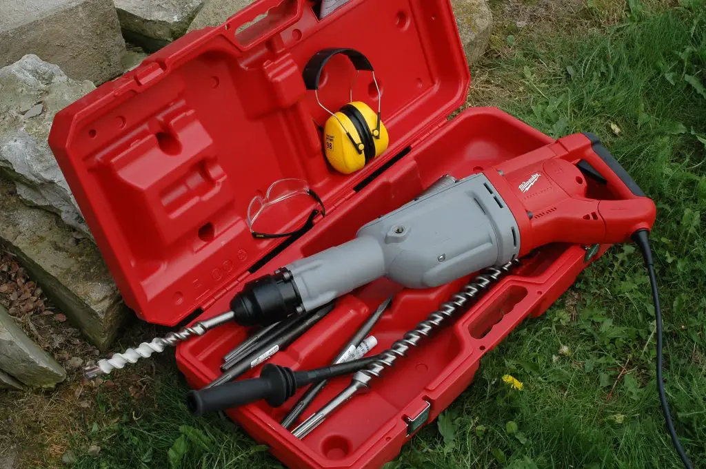 Red power drill with accessories in case.