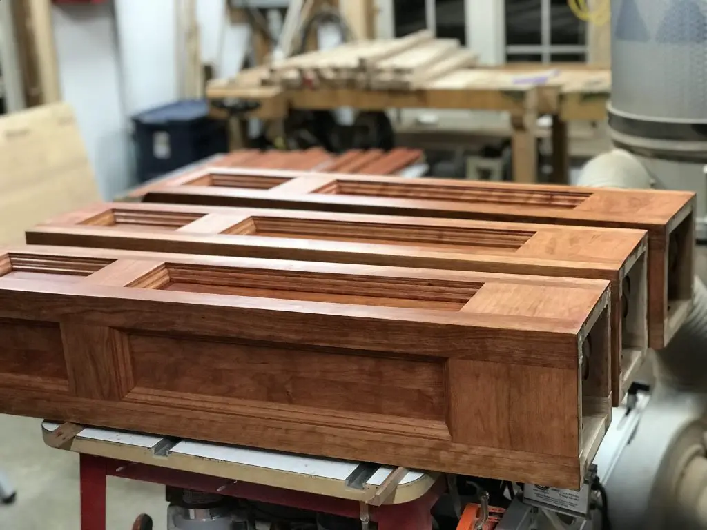 Handcrafted wooden cabinet doors in workshop.