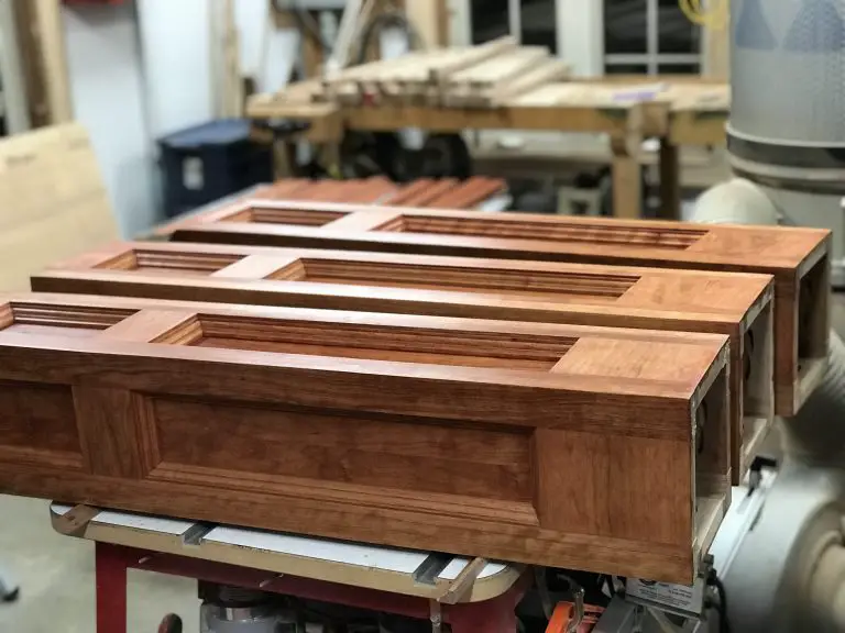 Handcrafted wooden cabinet doors in workshop.