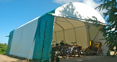 Outdoor storage tent with bikes and equipment inside