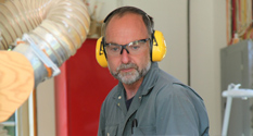 steve maxwell running a board through his DEWALT thickness planer