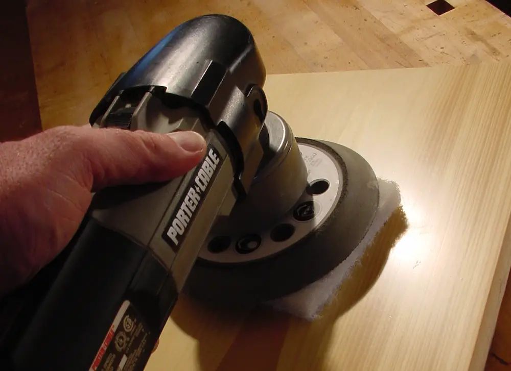 Using orbital sander on wooden surface
