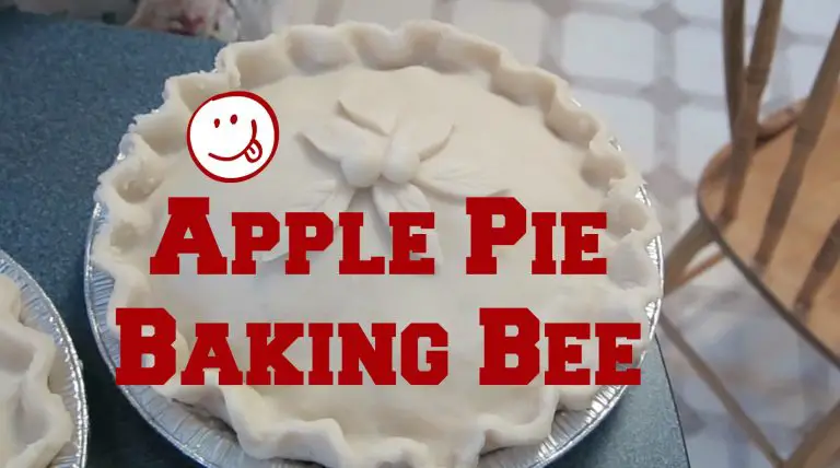 Decorative apple pie crust with baking event sign.