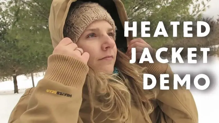 Woman wearing heated jacket outdoors in winter.