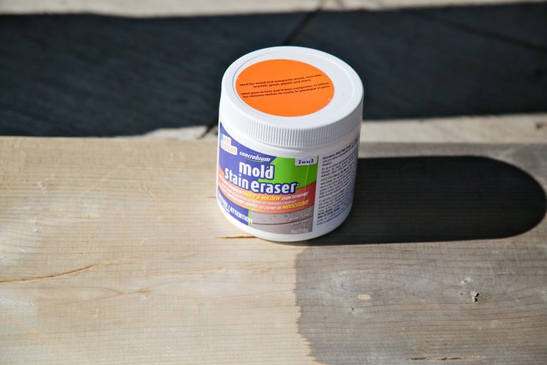 Mold stain remover on wooden surface, partial cleaned area.