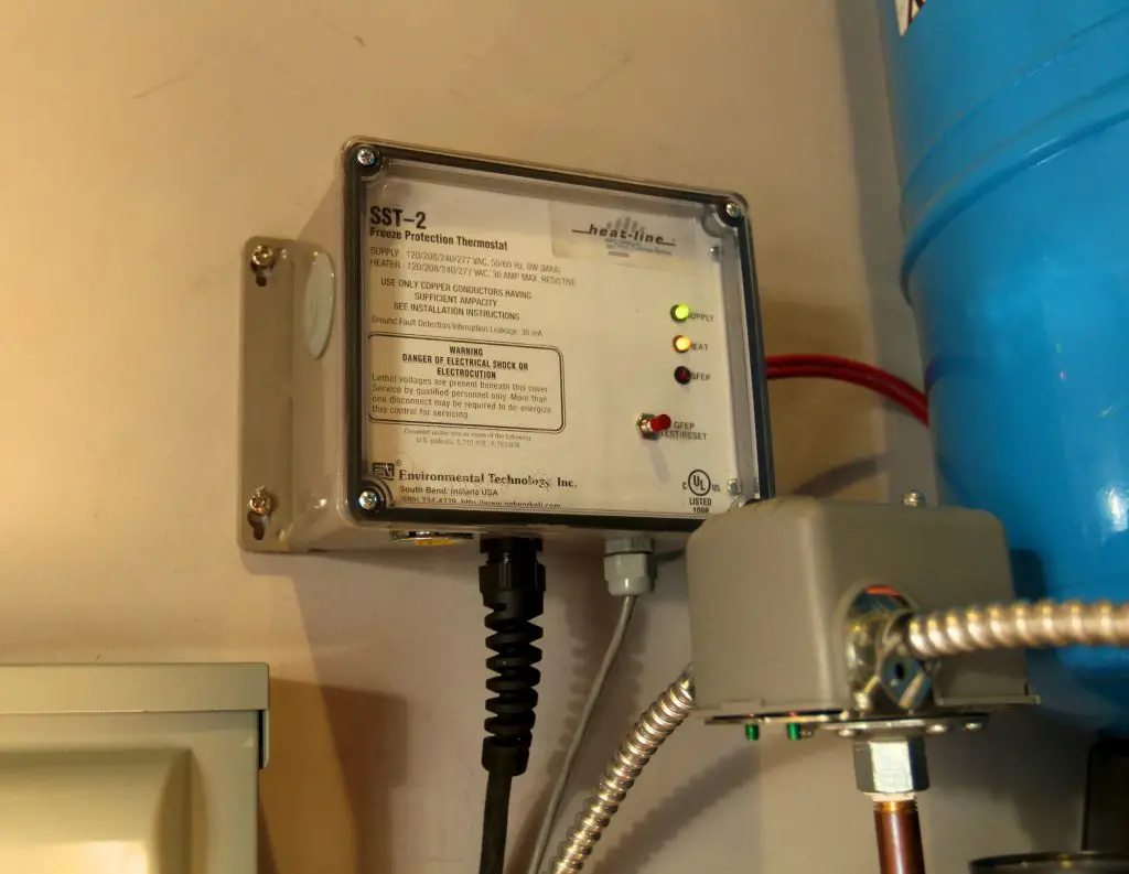 Freeze protection thermostat on wall.