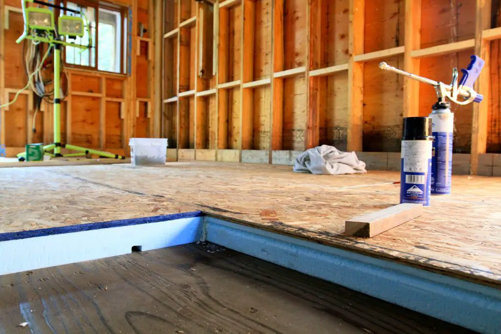 Insulated wooden floor under construction in a room.