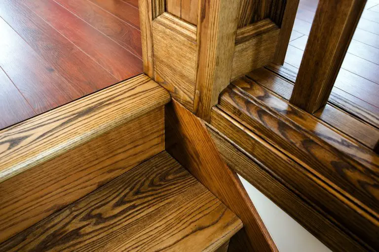Polished wooden stairs and railing corner detail