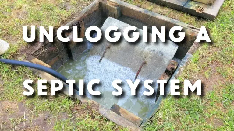 Septic system being unclogged outdoors with water flowing.