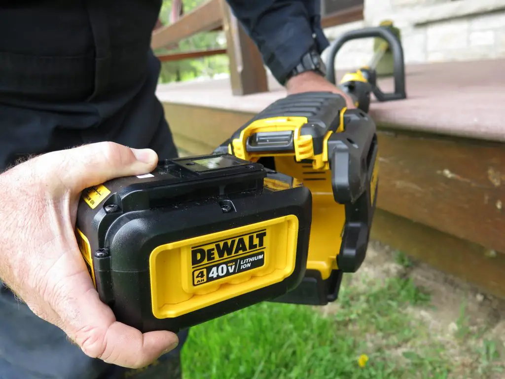 Worker holding cordless power tool in use