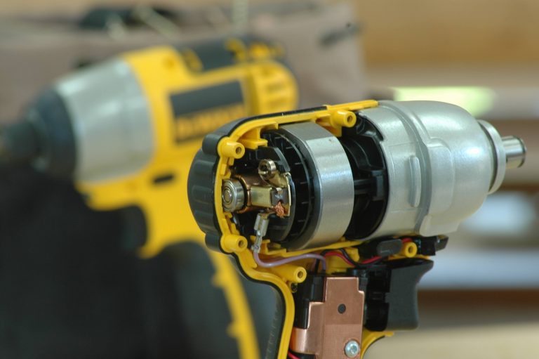 Yellow impact driver opened to show interior components.