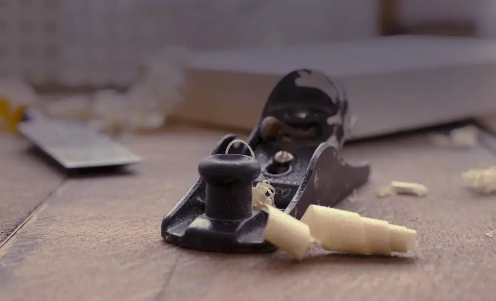 Close-up of woodworking plane with shavings