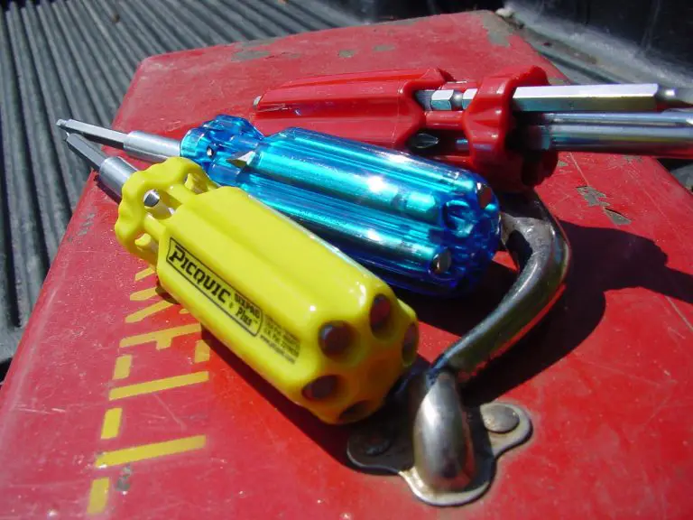 Colourful multi-bit screwdrivers on a red toolbox.