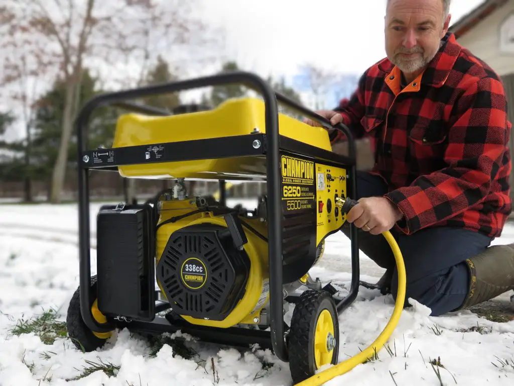 Man using yellow portable generator in snow