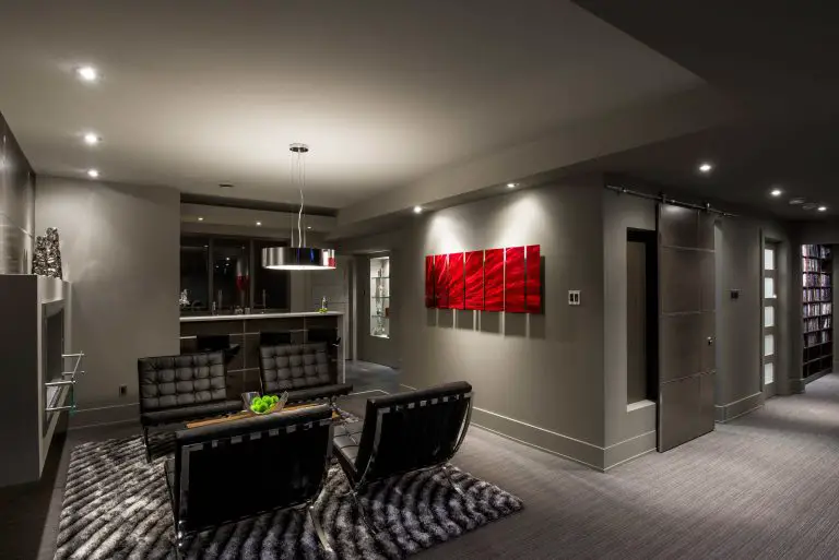 Modern living room with leather chairs and abstract art.