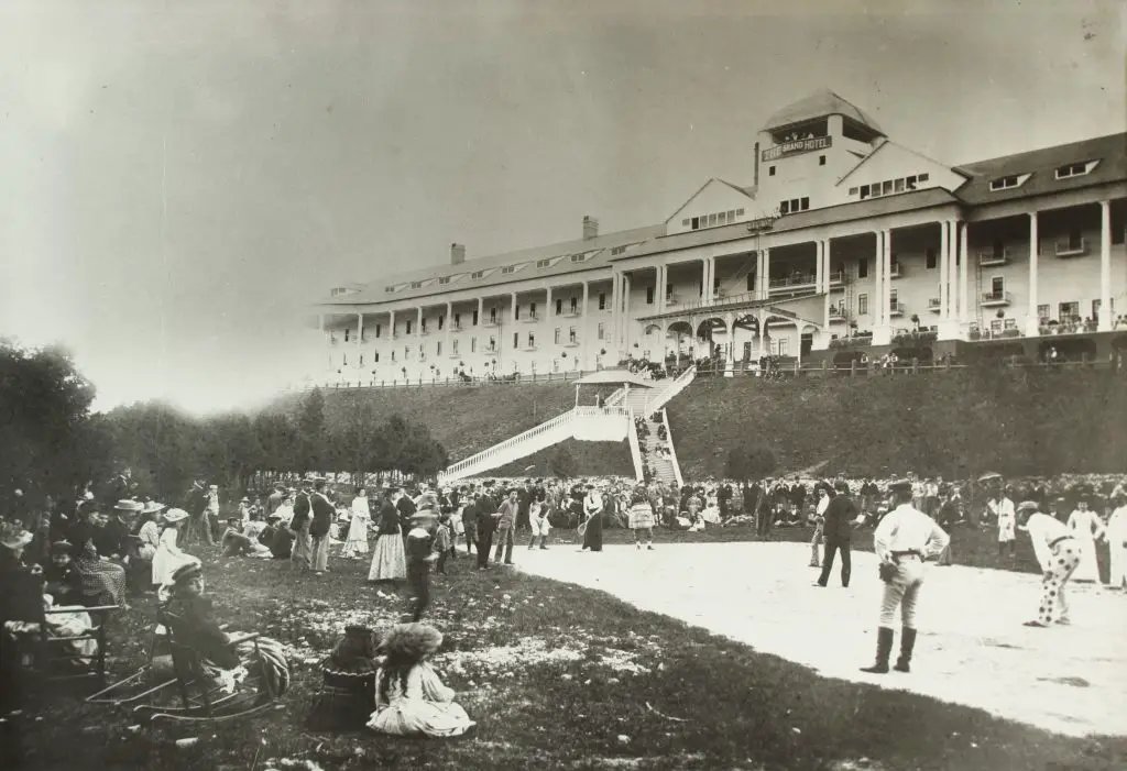 Historic hotel with people gathered outside, early 1900s