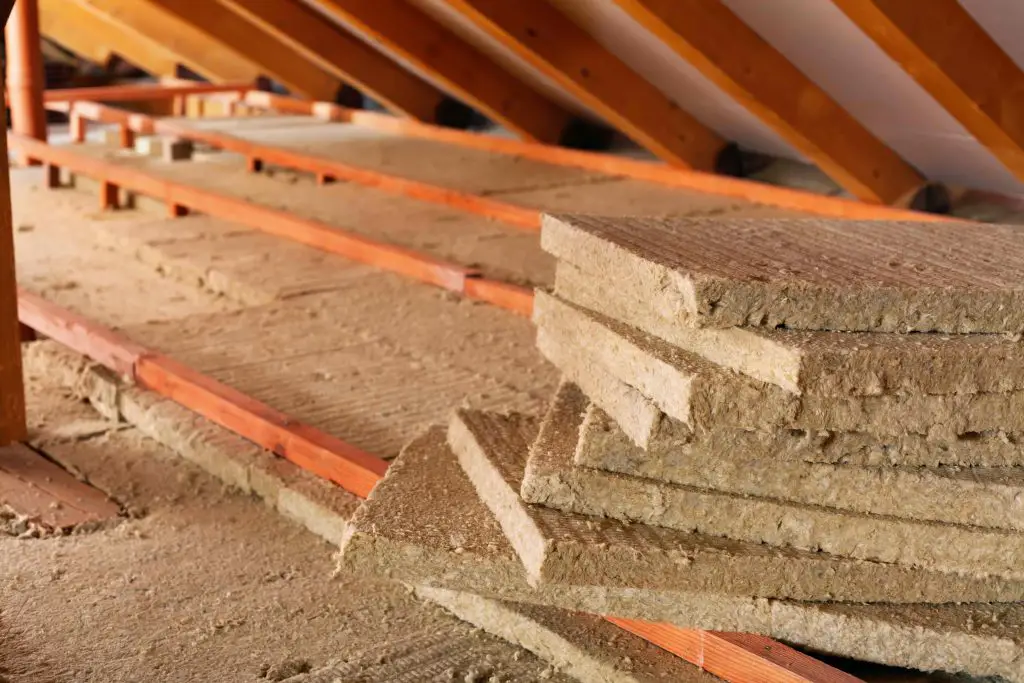 Attic with stacked insulation boards installed.