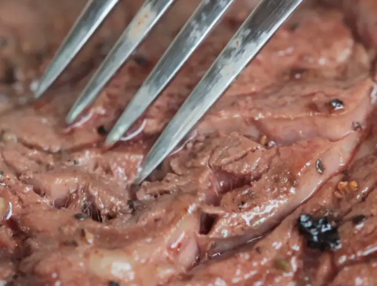 Close-up of fork in cooked steak