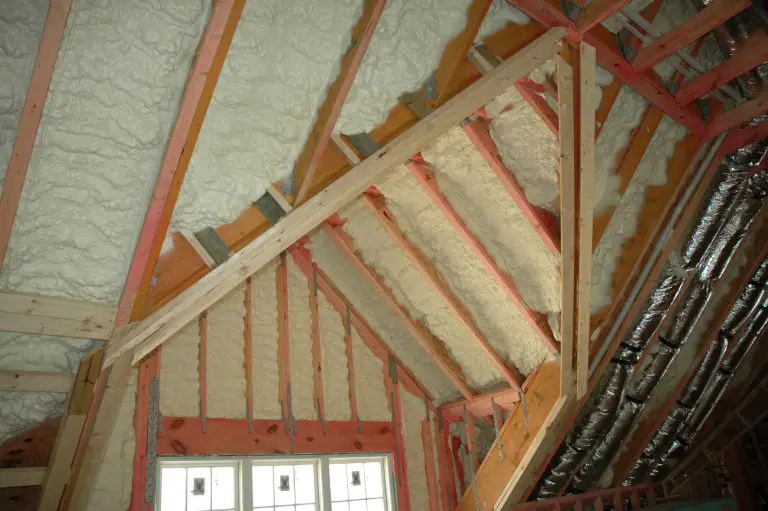 Attic with spray foam insulation installed on ceiling