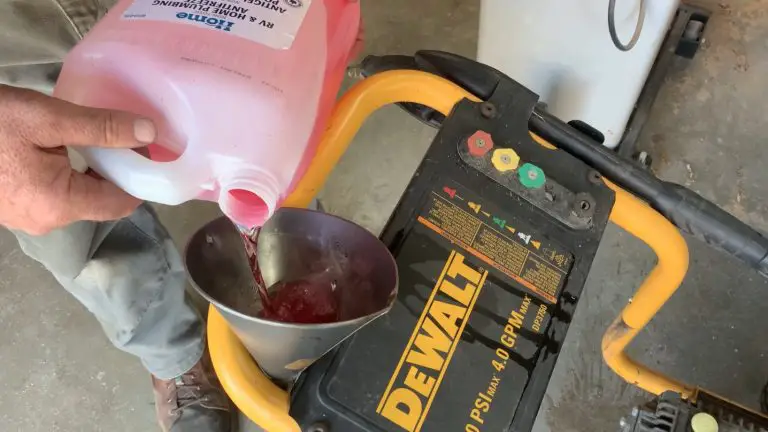 Pouring antifreeze into pressure washer with funnel.