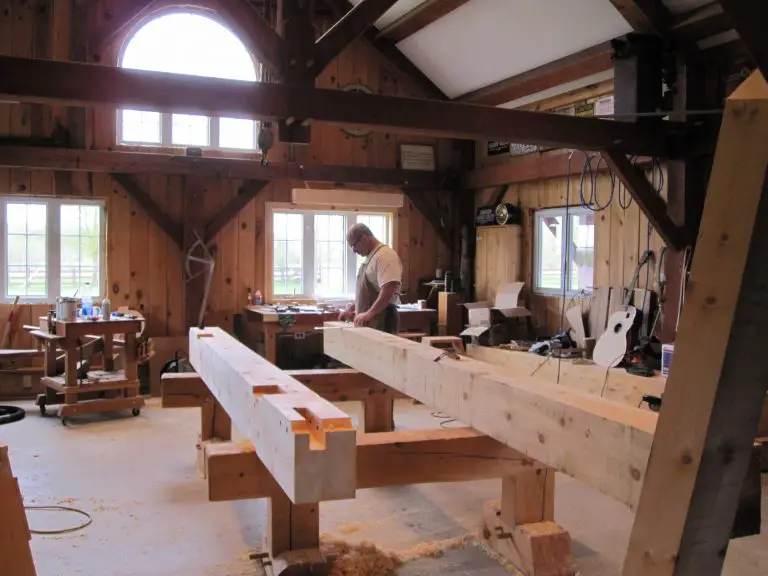Carpenter working in a rustic wood workshop.