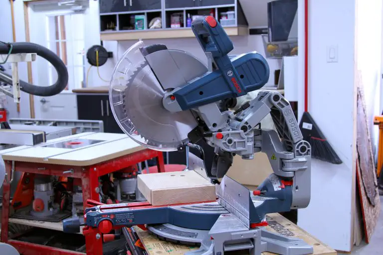Sliding miter saw in workshop cutting wood