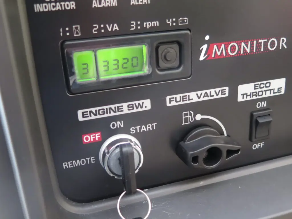 Generator control panel with display and switches.