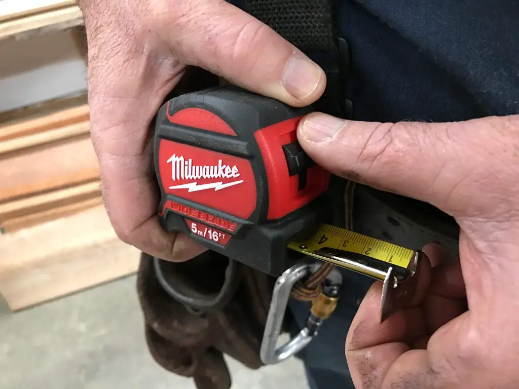 Using a Milwaukee tape measure for measurement.