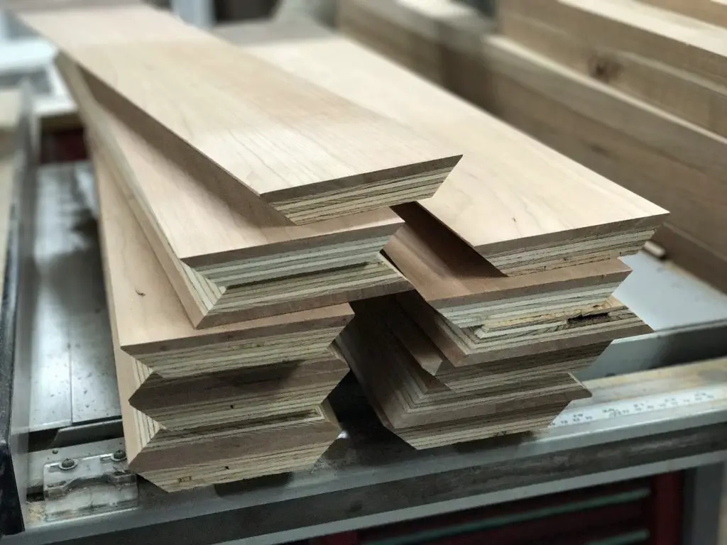 Stack of wooden boards on a workbench.