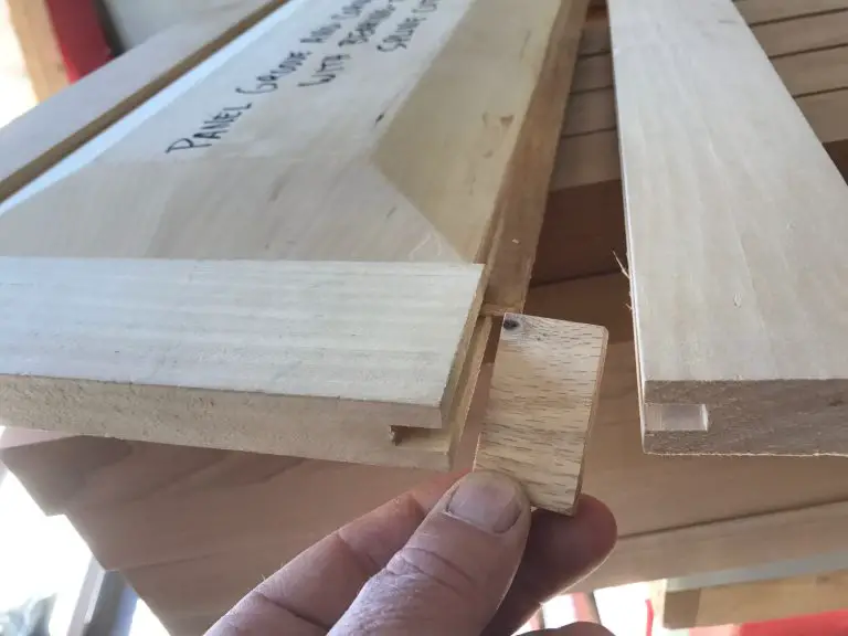 Hand holding wood joint piece for assembly