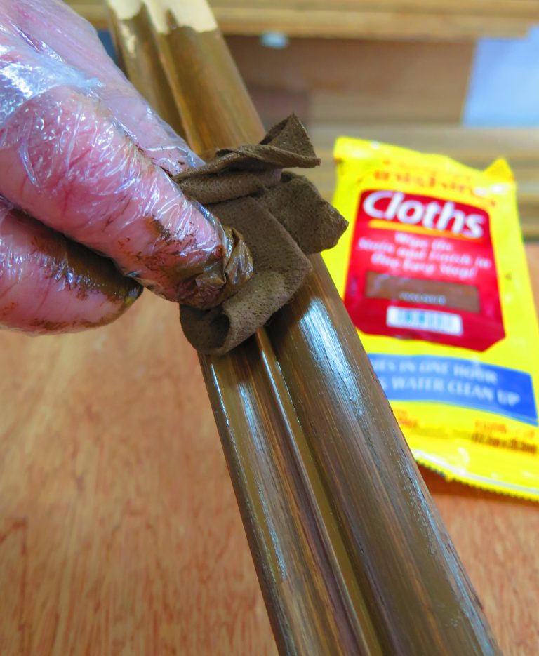 Staining wood with cloth and glove protection.