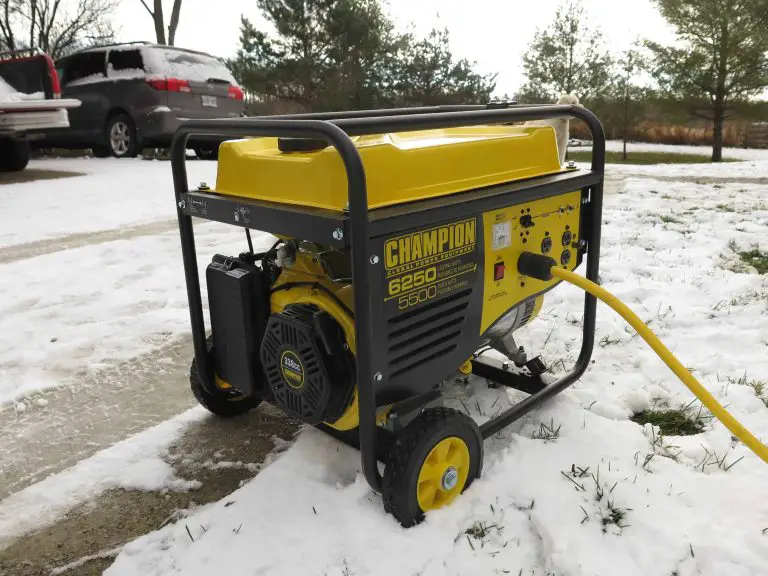 Yellow portable generator on snowy driveway.