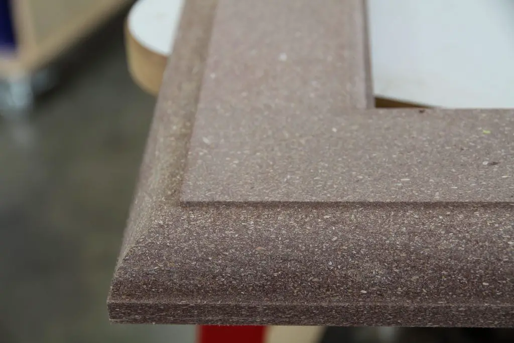 Close-up of brown particleboard furniture edge.