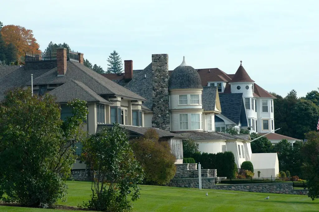 Charming residential houses with stone chimneys and gardens.