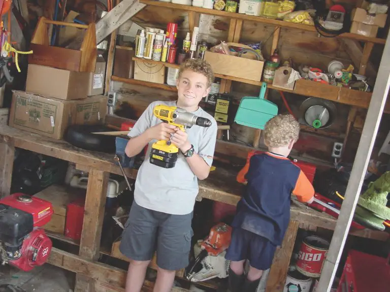 Kids in garage with tools and supplies.
