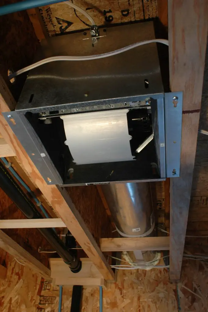 Ventilation duct installed in building ceiling.