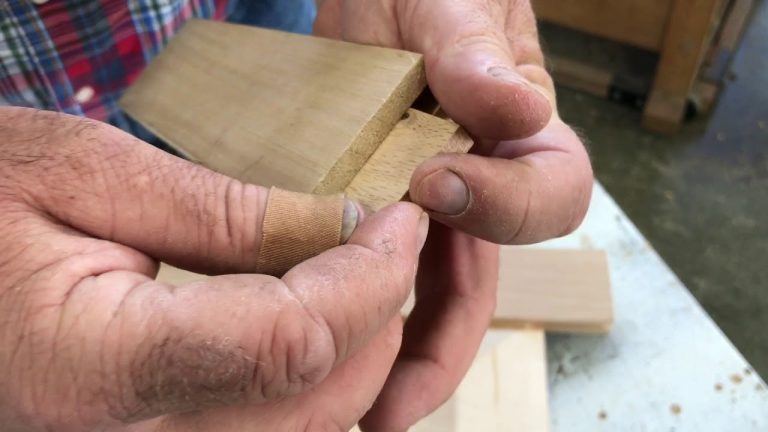 Hand fitting wooden joint piece together.