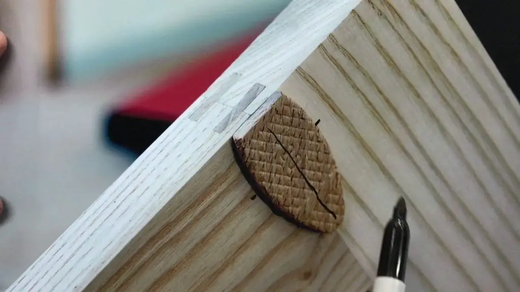 Wood joinery with biscuit and marker preparation.