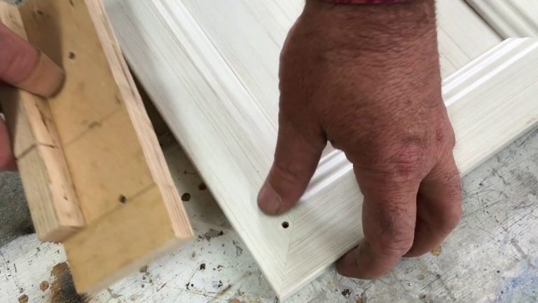 Hand assembling white wooden frame corner