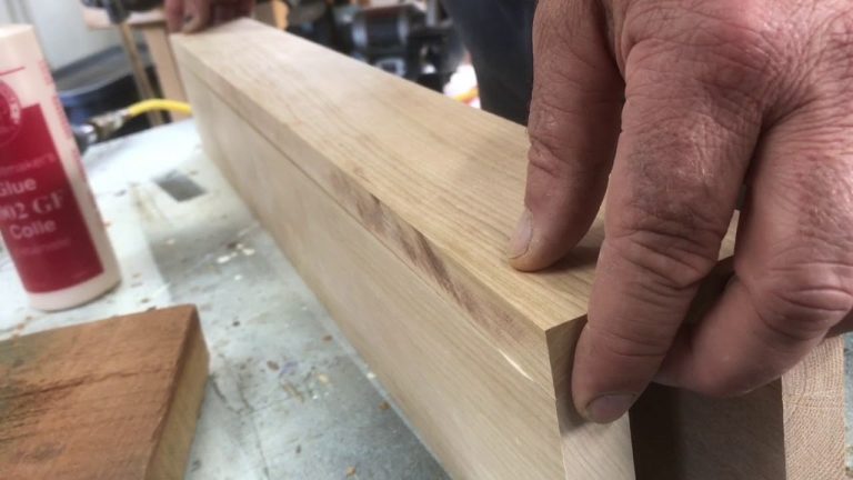 Person working with wooden plank and glue.