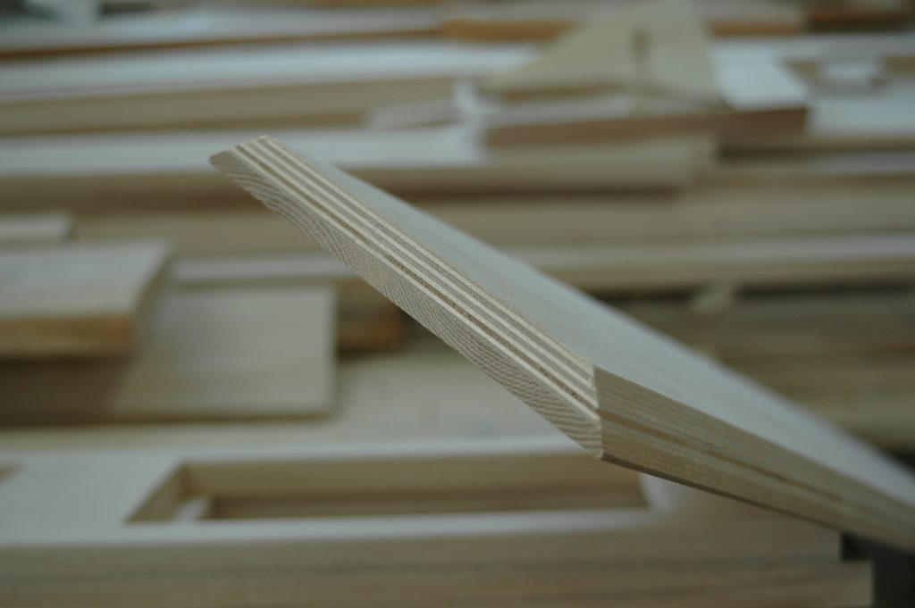 Close-up of plywood edge in workshop.