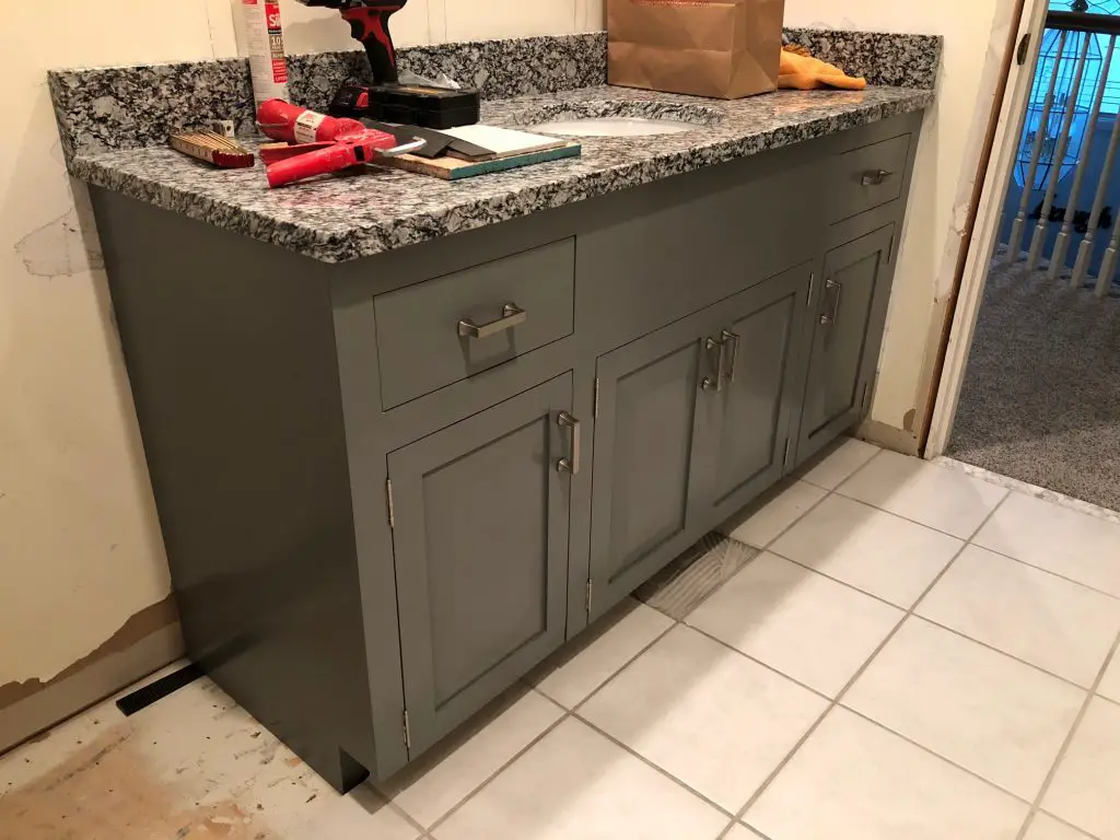 Grey bathroom cabinet with granite countertop