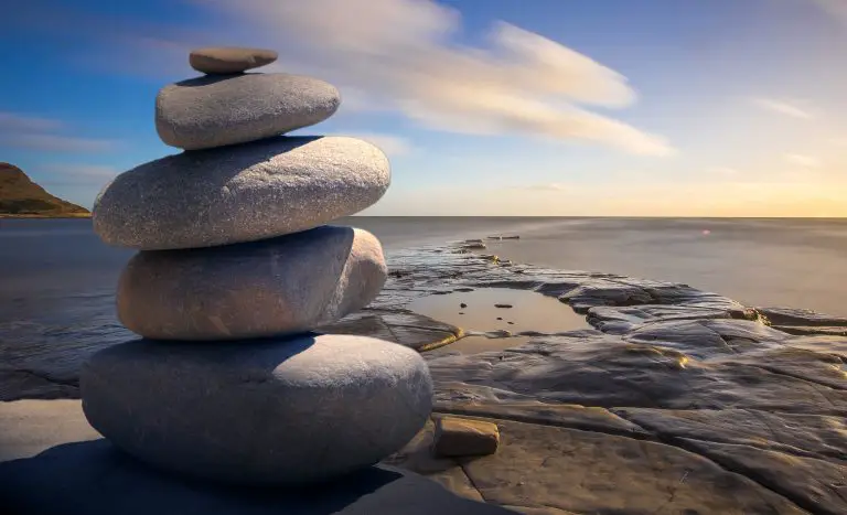 Stacked stones by the serene ocean view.
