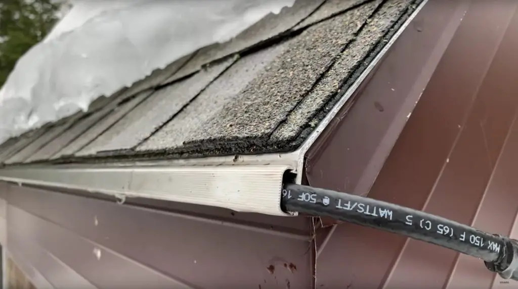 Snow-covered roof with visible black cable